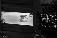 Young skaters, skater boys, skateboard down the deserted carpark at night in Auckland